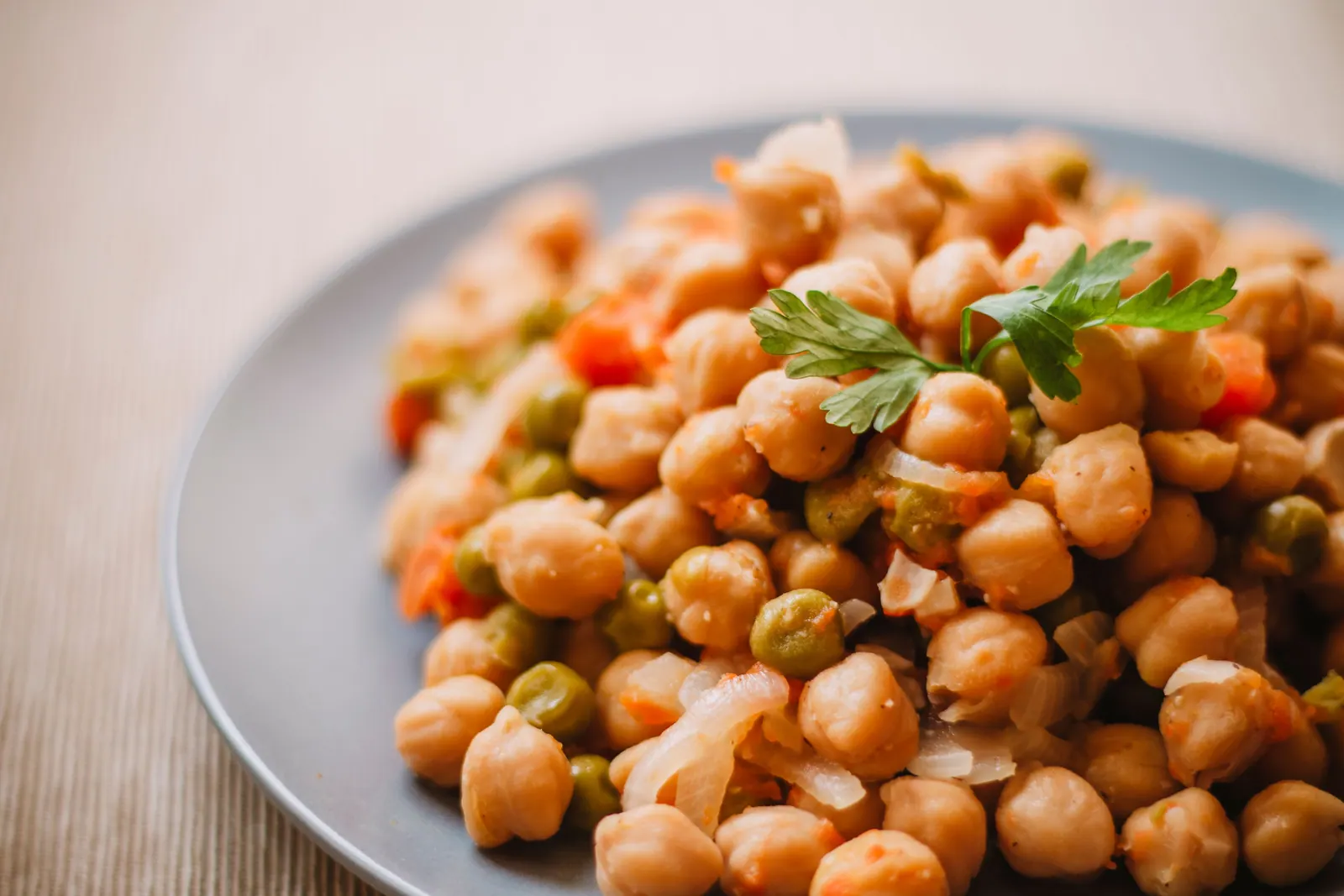 A chickpea salad with vegetables on a plate.
