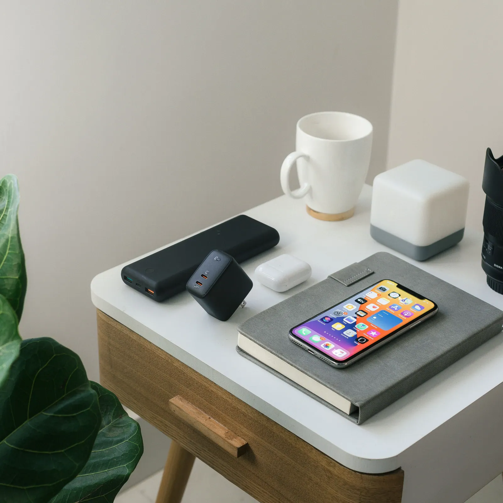 A smartphone and notebook on a desk.