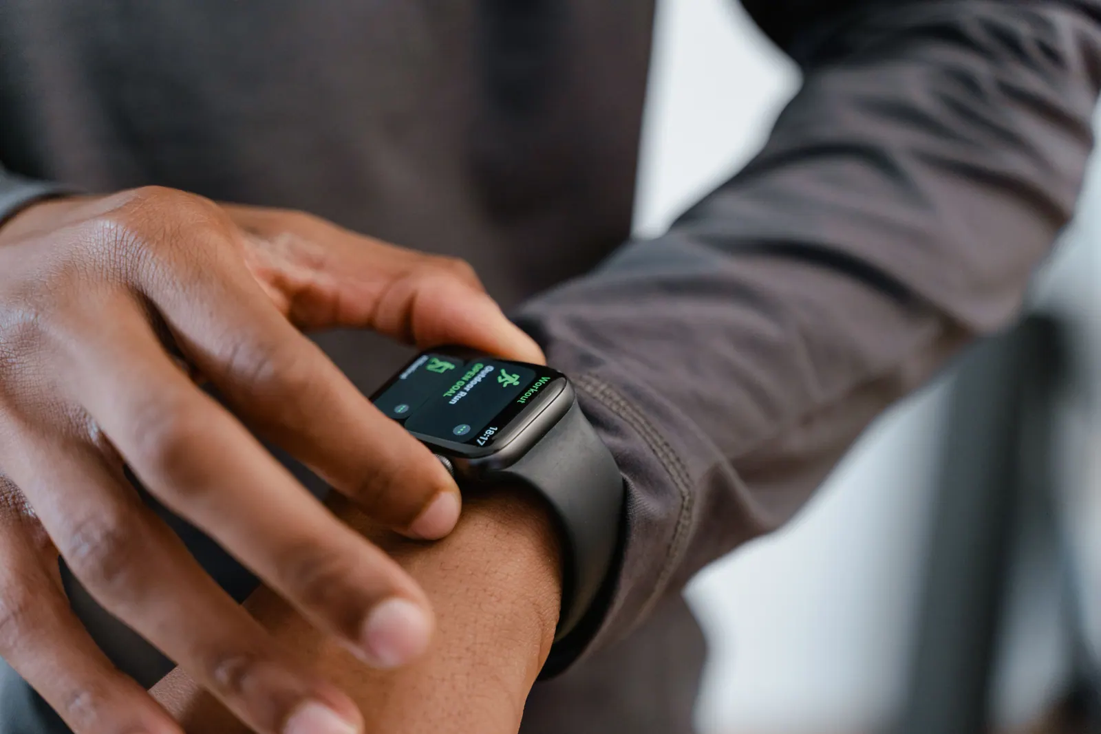 A person checking a smartwatch on their wrist.
