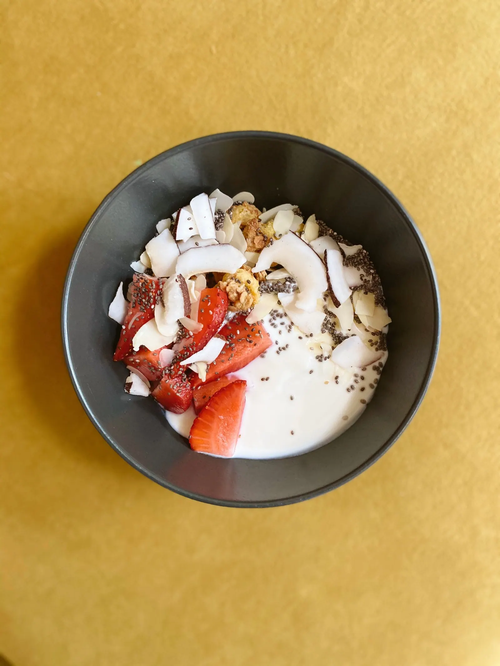 Yoghurt with strawberries, coconut and seeds.