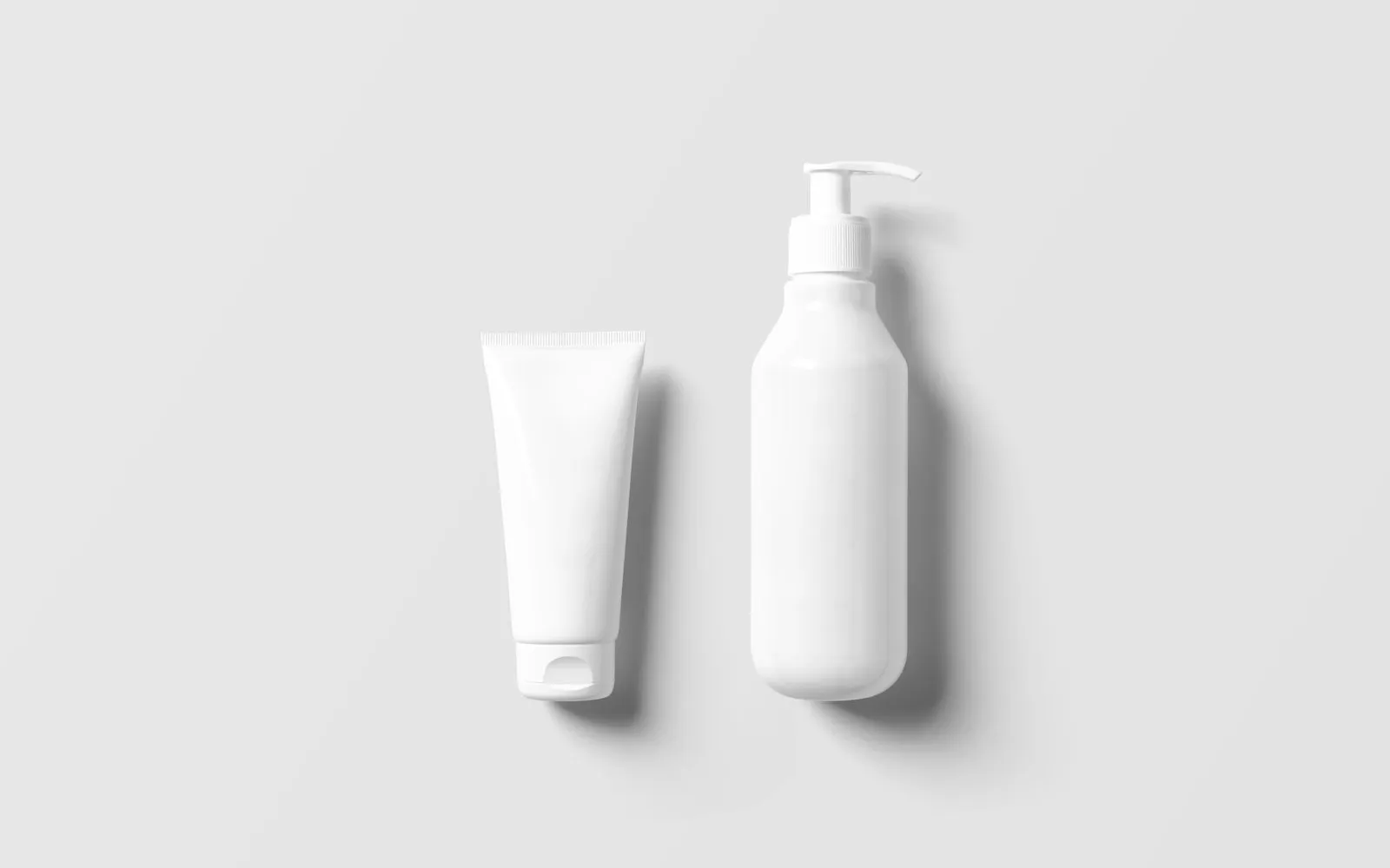 A plain white tube and a white pump bottle with no labels on a pale grey background