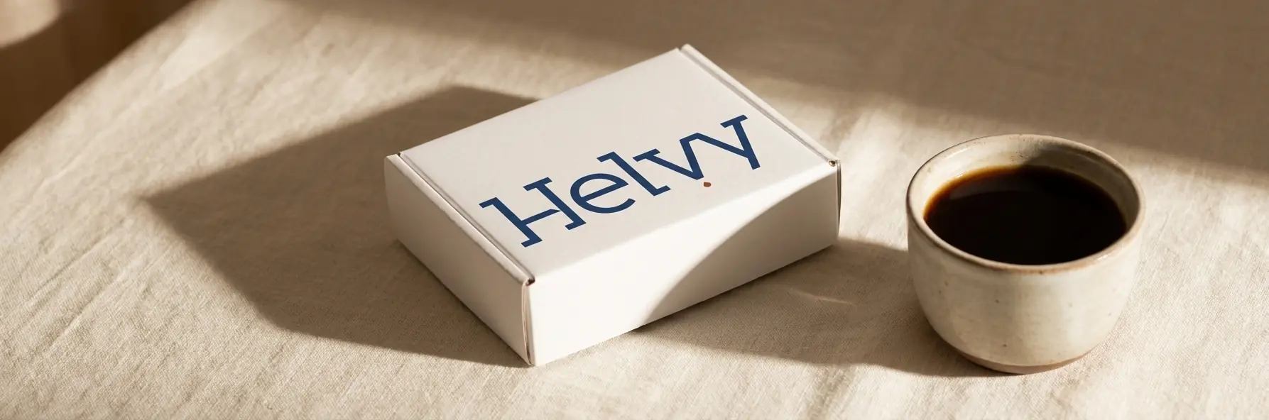 The Helvy home blood-test kit in soft morning light beside a cup of coffee